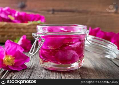 Rugosa rose flowers macerating in almond oil, to prepare a homemade skin product