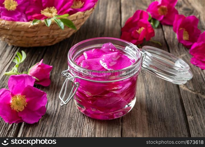 Rugosa rose petals macerating in almond oil, to prepare a homemade skin tonic