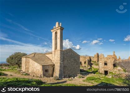 Ruined buildings and the restored church in the abandoned village of Occi near Lumio in the Balagne region of Corsica