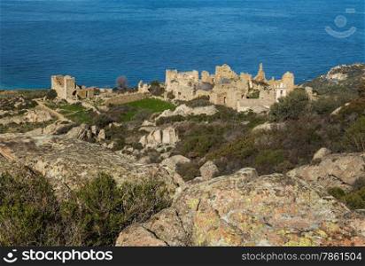 Ruined buildings and the restored church in the abandoned village of Occi near Lumio in the Balagne region of Corsica