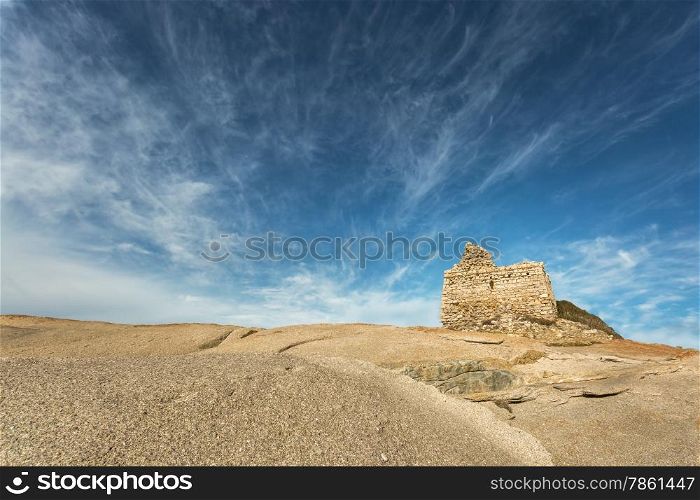 Ruined Genoese tower overlooking the mediterranean on rocks at Punta Caldanu near Lumio in Balagne region of Corsica