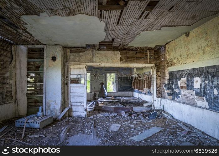 ruined interior of an old abandoned school house in rural Nebraska