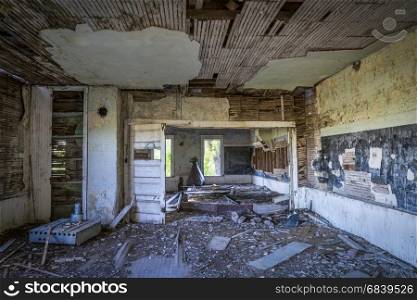 ruined interior of an old abandoned school house in rural Nebraska