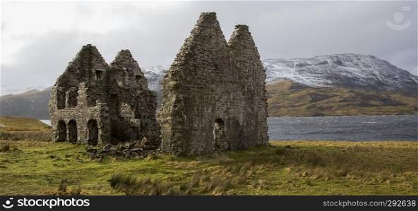 Ruins of an old Scottish manor house on the banks of Loch Assynt in northwest Scotland.