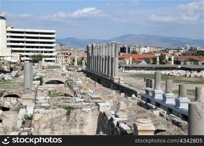 Ruins of ancient Agora in the city of Izmir in Turkey with modern buildings in the background