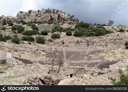 Ruins of ancient theater on the slope of hill in Assos in Turkey