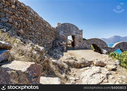 Ruins of apartments on the island of Spinalonga. Spinalonga fortress on the island of Crete, Greece. Here were isolated lepers, humans with Hansen’s disease.. Ruins of apartments on the island of Spinalonga. Spinalonga fortress on the island of Crete, Greece.