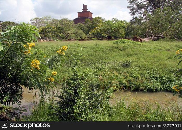 Ruins of brick dagoba in Anuradhapura and river