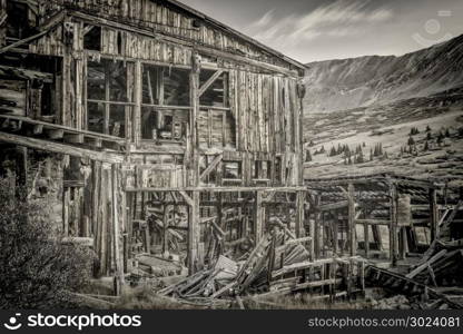 ruins of gold mine (processing mill) near Mosquito Pass in Rocky Mountains, Colorado, black and white image