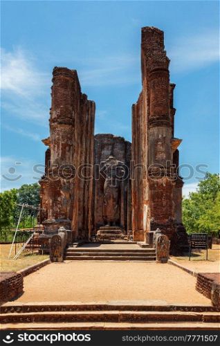 Ruins of Lankatilaka Vihara - temple with Buddha image. Ancient city of Pollonaruwa - famous tourist attraction and archaelogical site, Sri Lanka. Ruins of Lankatilaka Vihara temple with Buddha image. Pollonaruwa, Sri Lanka
