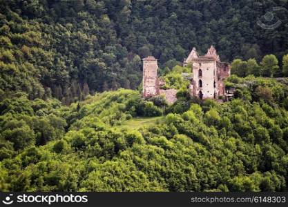 Ruins of old castle in the middle of the forest hills, Ukraine