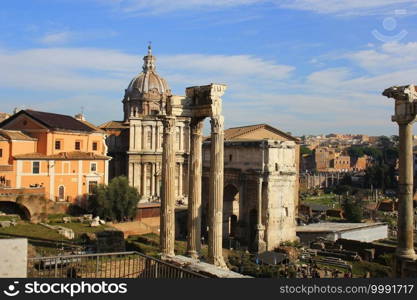 Ruins of Roman Forum. Temple of Vespasian and Titus, Arch of Septimius Severus and church of Santi Luca e Martina in Rome. Italy