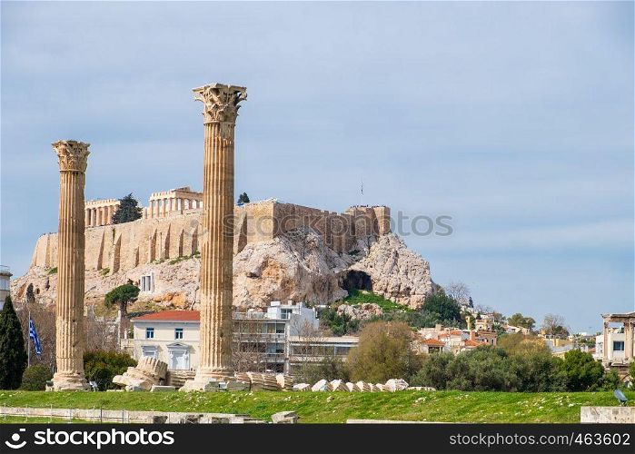 Ruins of the ancient Temple of Olympian Zeus in Athens (Olympieion or Columns of the Olympian Zeus) with Acropolis hill in the background