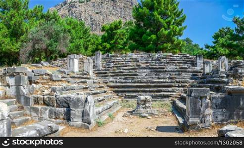 Ruins of the Bouleuterion or council house in the ancient city of Priene, Turkey, on a sunny summer day.. The Bouleuterion in Ancient Priene ruins, Turkey