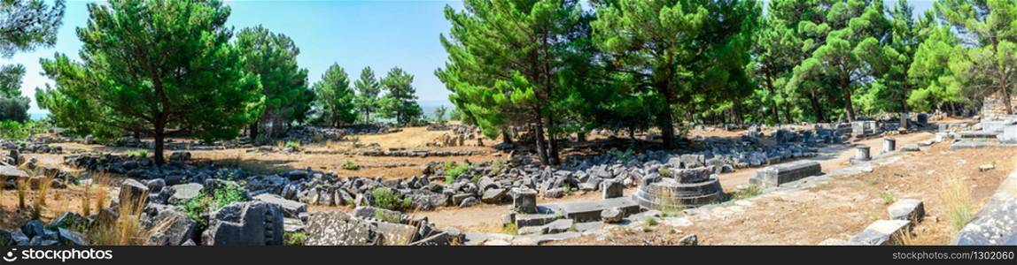 Ruins of the Western Gate street in the ancient city of Priene, Turkey, on a sunny summer day.. The Western Gate street in Ancient Priene, Turkey