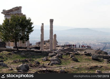 Ruins of Trajan temple and tourists in Pergam, Turkey