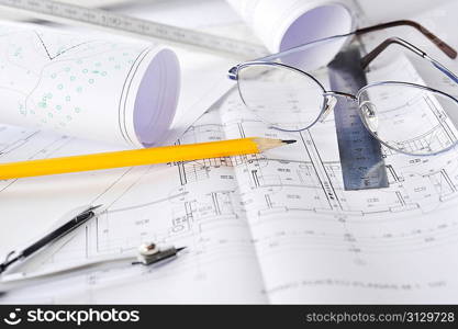 Ruler, eraser, glasses and a pencil on the floor plan - Bussines a still-life