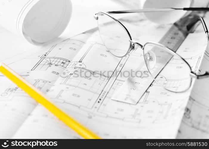 Ruler, eraser, glasses and a pencil on the floor plan - Bussines a still-life&#xA;