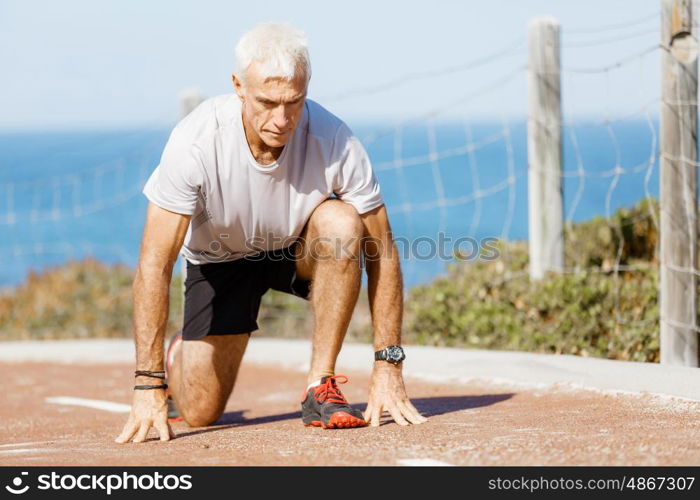 Runner getting ready to start the race. Male runner getting ready to start his race