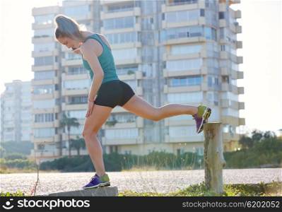 Runner girl having a rest and talking smartphone telephone outdoor building park