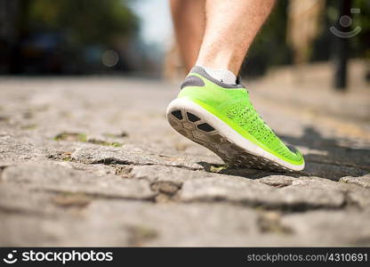 Runner jogging on cobbled street