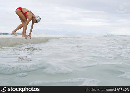 Runner jumping into water from dock