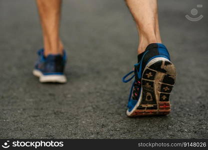 Runner man feet running on road closeup on shoe. Sports healthy lifestyle concept.