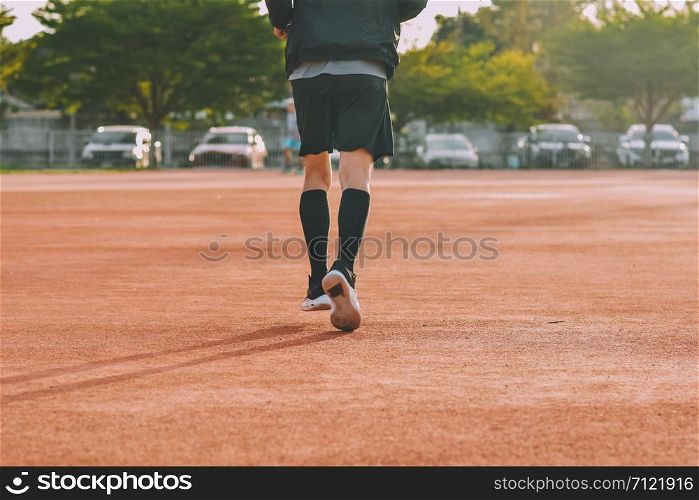 Runner Man jogging or running in evening at sunlight