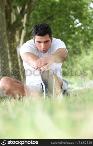 Runner stretching on grass
