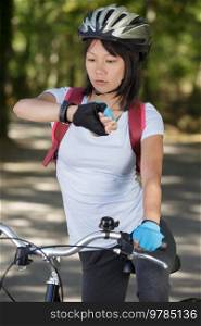 runner wearing fitness smart watch while cycling
