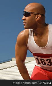 Runner with sunglasses on a track