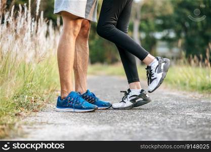 Runner woman and man feet running on road closeup on shoe. Sports healthy lifestyle concept.