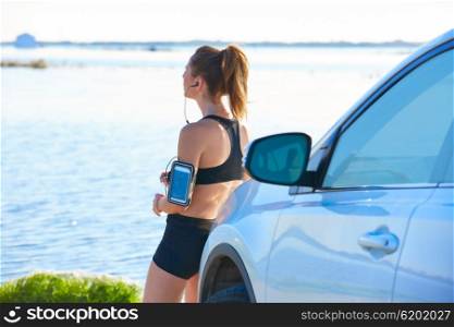 Runner woman relaxing after workout outdoor with water bottle in a lake