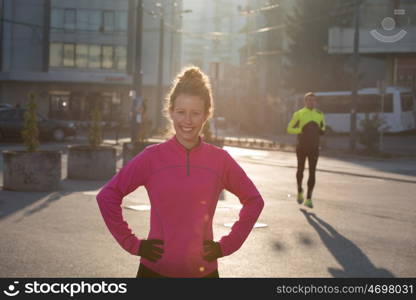 runner woman warming up and stretching before morning jogging