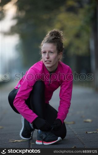 runner woman warming up and stretching before morning jogging