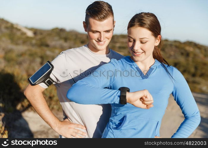 Runner woman with heart rate monitor running on beach. Young runner woman with heart rate monitor running on beach