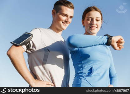 Runner woman with heart rate monitor running on beach. Young runner woman with heart rate monitor running on beach