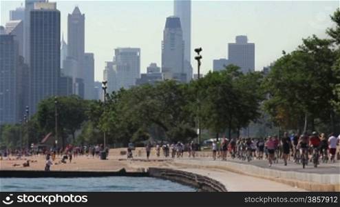 Runners and cyclists on the Lakeshore Path with the Chicago skyline in the background