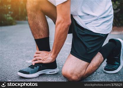 Runners injured on the ankle,Man running on the street be running for exercise,Run sports background