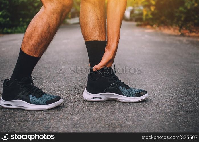 Runners injured on the ankle,Man running on the street be running for exercise,Run sports background