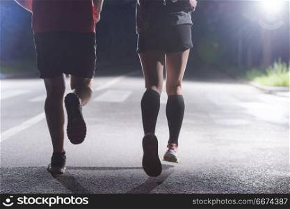 runners team on the night training. group of healthy people jogging in city park, runners team at night training