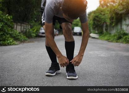 Runners tied in shoes,Man run on the street be running for exercise,Run sports background and closeup at running shoe