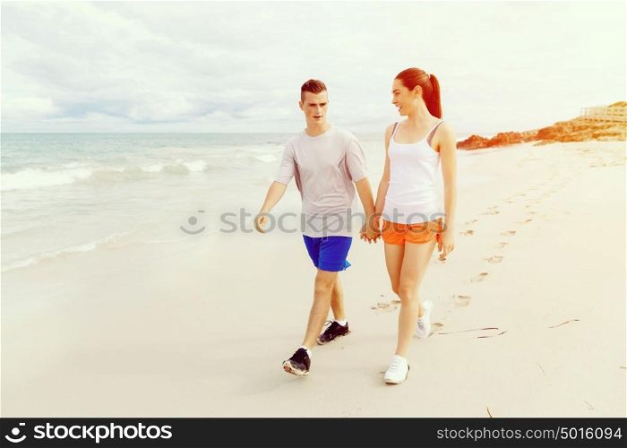 Runners. Young couple running on beach. Runners. Young couple running on beach together