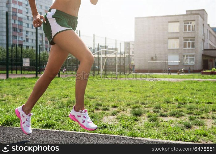 running at outdoor. A young beauty athletic woman in sportswear running at outdoor.