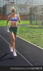 running at outdoor. A young beauty athletic woman in sportswear running at outdoor early morning. Healthy lifestyle.