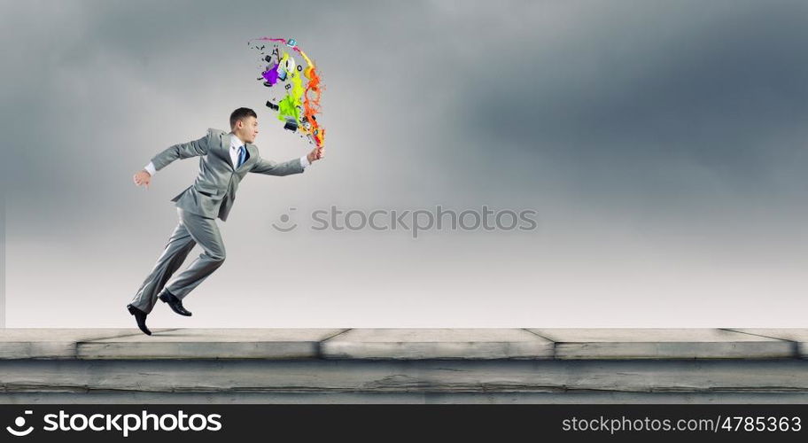 Running businessman. Cheerful young businessman running in a hurry