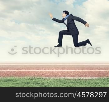 Running businessman. Funny image of running businessman at stadium. Competition concept