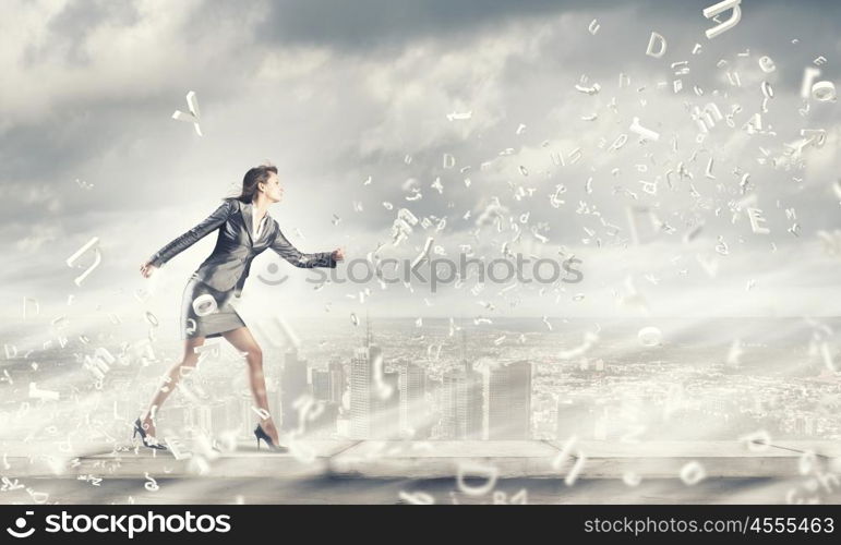 Running businesswoman. Young businesswoman in suit running in a hurry