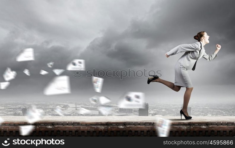 Running businesswoman. Young businesswoman in suit running in a hurry