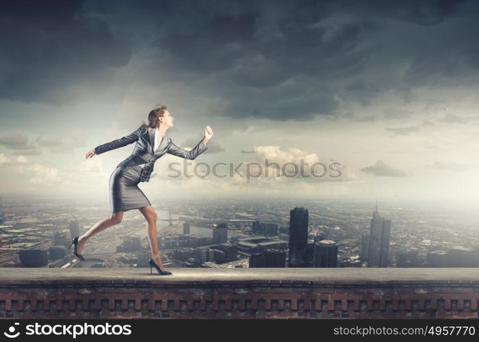 Running businesswoman. Young businesswoman in suit running in a hurry